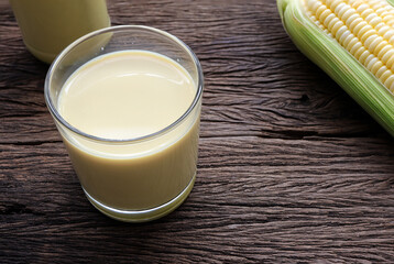Sweet corn juice ,corn milk and corn on wooden table. Healthy drink