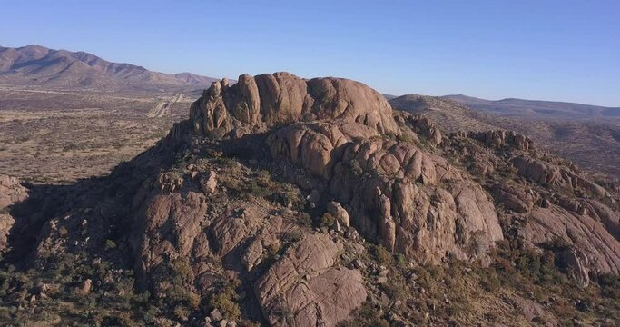 4K aerial drone video of African savanna hills, large red granite boulders range near B1 highway south of Windhoek in central highland Khomas Hochland of Namibia, southern Africa