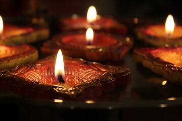 Handmade, traditional diyas lit up with flame during Diwali (the Indian festival of lights)