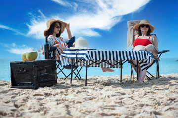Relation friendships happy sitting in folding chairs relaxing on tropical beach