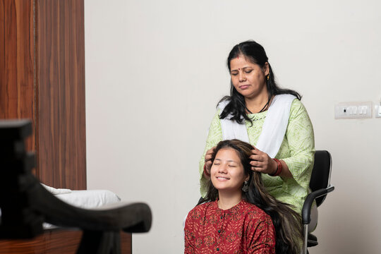 An Indian Girl Getting Her Head Massage By Her Mother, Daughter And Mother Love For Mother's Day Concept.