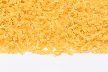 Uncooked Fusilli Pasta with Copy Space on White Background. Raw and Dry Macaroni. Fat and Unhealthy Food - Flat Lay
