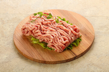 Raw minced pork meat over board