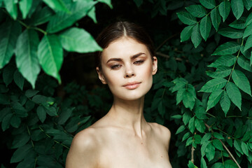 smiling woman skin care bare shoulders green leaves nature close-up
