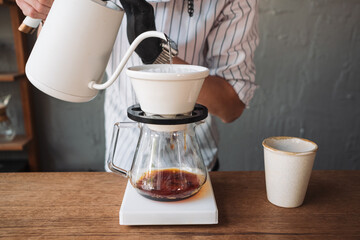 barista dripping coffee and slow coffee bar style