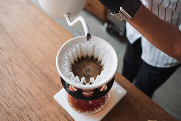 barista dripping coffee and slow coffee bar style