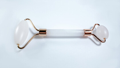 White massage quartz roller for the face close-up isolated on a white background. Beauty and care...