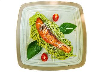 Salmon pesto sauce pasta dish with basil tomato pepper isolate die cut on white background