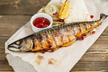 grilled mackerel and a salad of fresh vegetables. Serving on a wooden Board on a rustic table. Barbecue restaurant menu, a series of photos of different meats anf fish