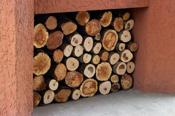 A neatly stacked woodpile cooked next to the oven