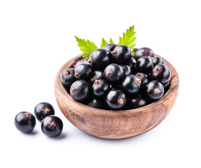 Sweet black currants in wooden plate