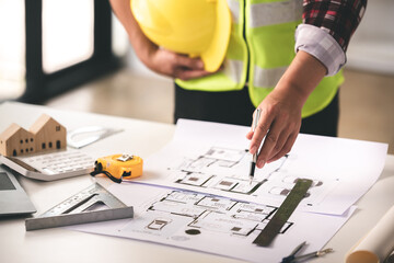 architect concept, working architect with blueprints in office to present to customers