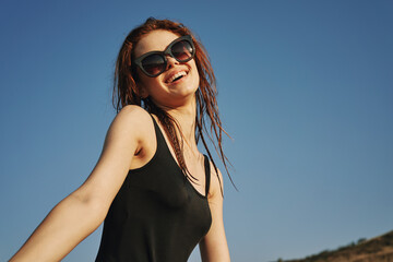 woman in black swimsuit sunglasses sun nature