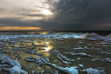 Winter landscape with a river covered with snow and ice hummocks. Ob River, Western Siberia