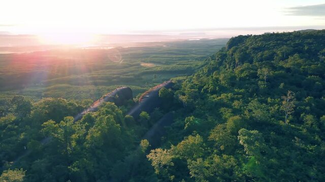Aerial view POI over Exotic landscape with the rainbow in the morning sky at Three Whale Rocks the stone shaped like a whale, a famous tourist attraction of Bueng Kan province amazing Thailand
