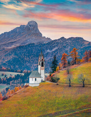 Beautiful autumn scenery. Impressive autumn view of  Santa Barbara church, San Genesio village location, Province of Bolzano - South Tyrol, Italy, Europe. Architectural background..