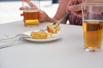 Hand taking a piece of Spanish omelette with a fork.