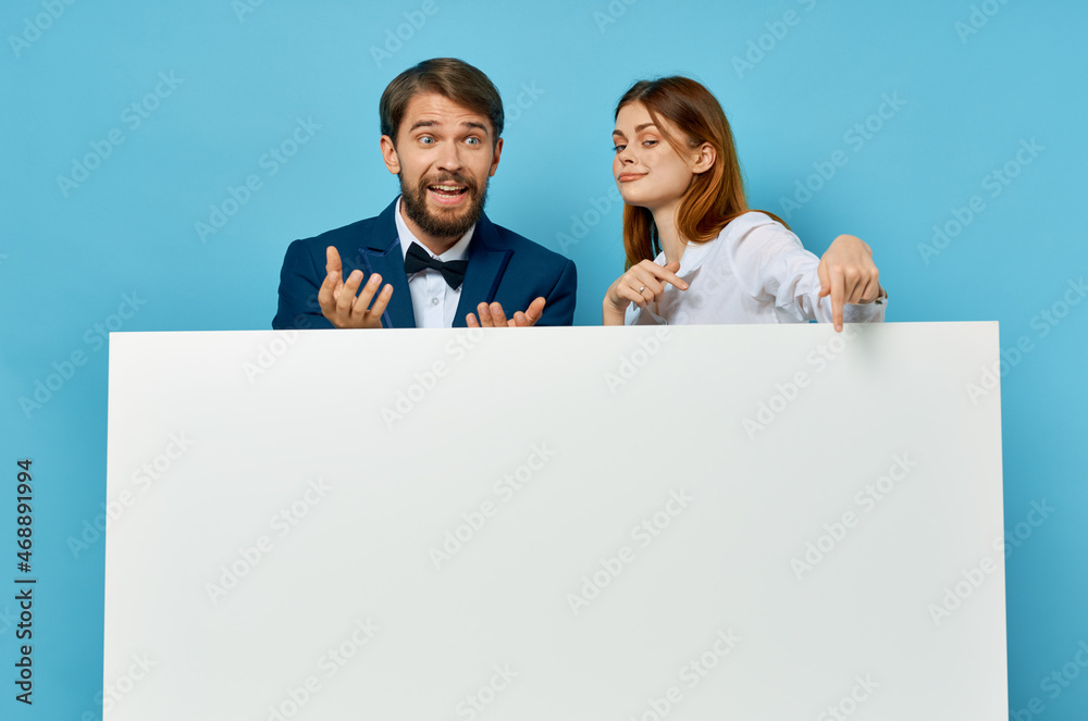 Wall mural Man and woman advertising presentation white banner copy-space studio