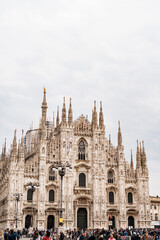 Fototapeta na wymiar View of the marble facade of the Duomo Cathedral. Italy, Milan