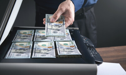 Man copying a money on a copy machine.