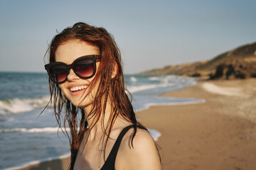 cheerful woman sunglasses posing black swimsuit island