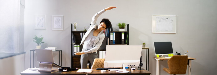 Stretching Exercise At Desk. African American Woman