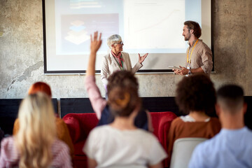 Naklejka na ściany i meble Senior colleagues holding a presentation
