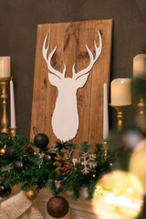 Christmas fireplace with candles and decorative deer head
