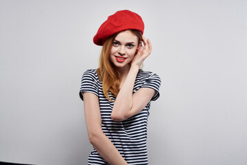Naklejka premium cheerful woman in a striped t-shirt red lips gesture with his hands isolated background