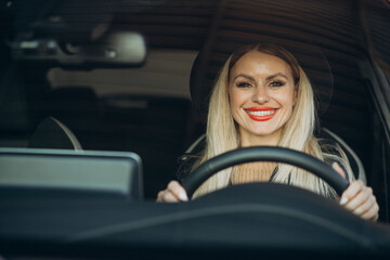 Fototapeta na wymiar Pretty woman sitting in her car