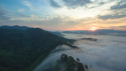 aerial view mist above the mountain in tropical rainforest and .beautiful sunrise scenery view in Phang Nga valley.