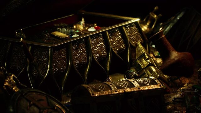 treasures in a dark cave with coins diamonds and gold