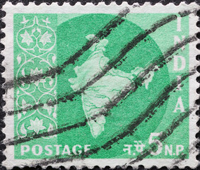 India - circa 1957: a postage stamp from India showing the silhouette of the map of India decorated with a floral pattern. green