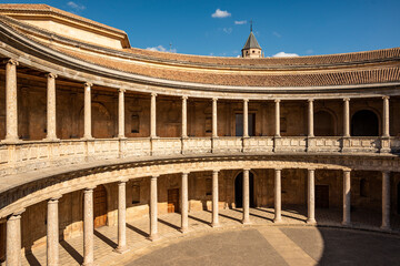 Fototapeta premium The unique circular patio of the Palace of Charles V (Palacio de Carlos V) with its two levels of columns in form of Doric and Ionic colonnades, Alhambra de Granada, Andalusia, Spain