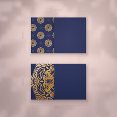 Presentable business card in dark blue with abstract gold ornaments for your business.