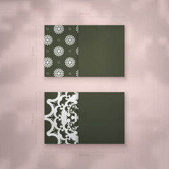 The business card is dark green with an abstract white ornament for your contacts.