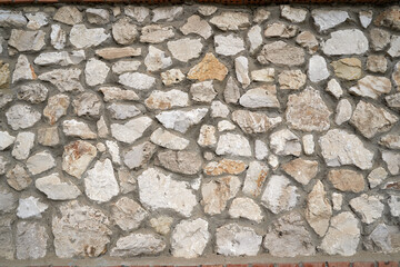    Old brick wall, old texture of red stone blocks closeup        
