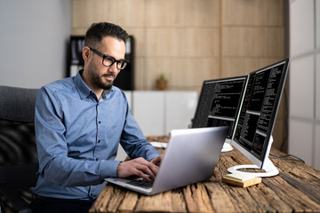 Coder Using Computer At Desk