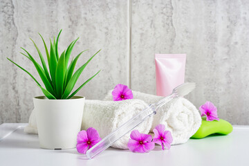 Obraz na płótnie Canvas Toothbrush, toothpaste and white towels, pink flowers with copy space. Aromatherapy and Oral care, body hygiene and morning daily routines.