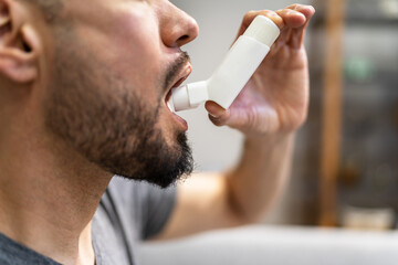Man With Asthma Using An Asthma Inhaler