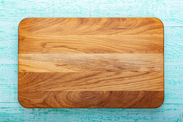 Multifunctional wooden chopping board for cutting bread, pizza or steak on wood background