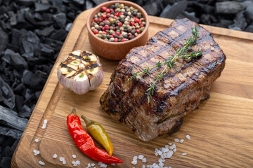 Piece of cooked rump steak with spices served