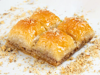 Turkish desert baklava with peanut, havuç dilim, midye, sarma, ramadan on the white plate turkish tasty