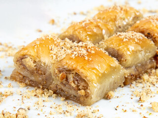 Turkish desert baklava with peanut, havuç dilim, midye, sarma, ramadan on the white plate turkish tasty