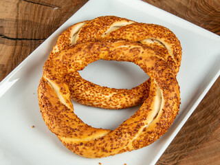 pretzel on white plate on wood