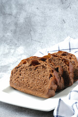 Slice of chocolate soft bread in white plate