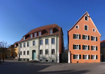 Fototapeta na wymiar City square with a baroque school building and the gable facade of a residential house in the old town of Herrieden, Franken region in Germany