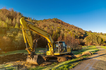 Industrial excavator on clears the territory, collects the earth in a bucket