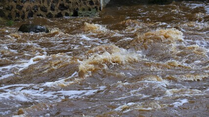 turbulence caused by an overflowing river causing spray