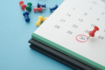 deadline concept with push pin on calendar date close up 